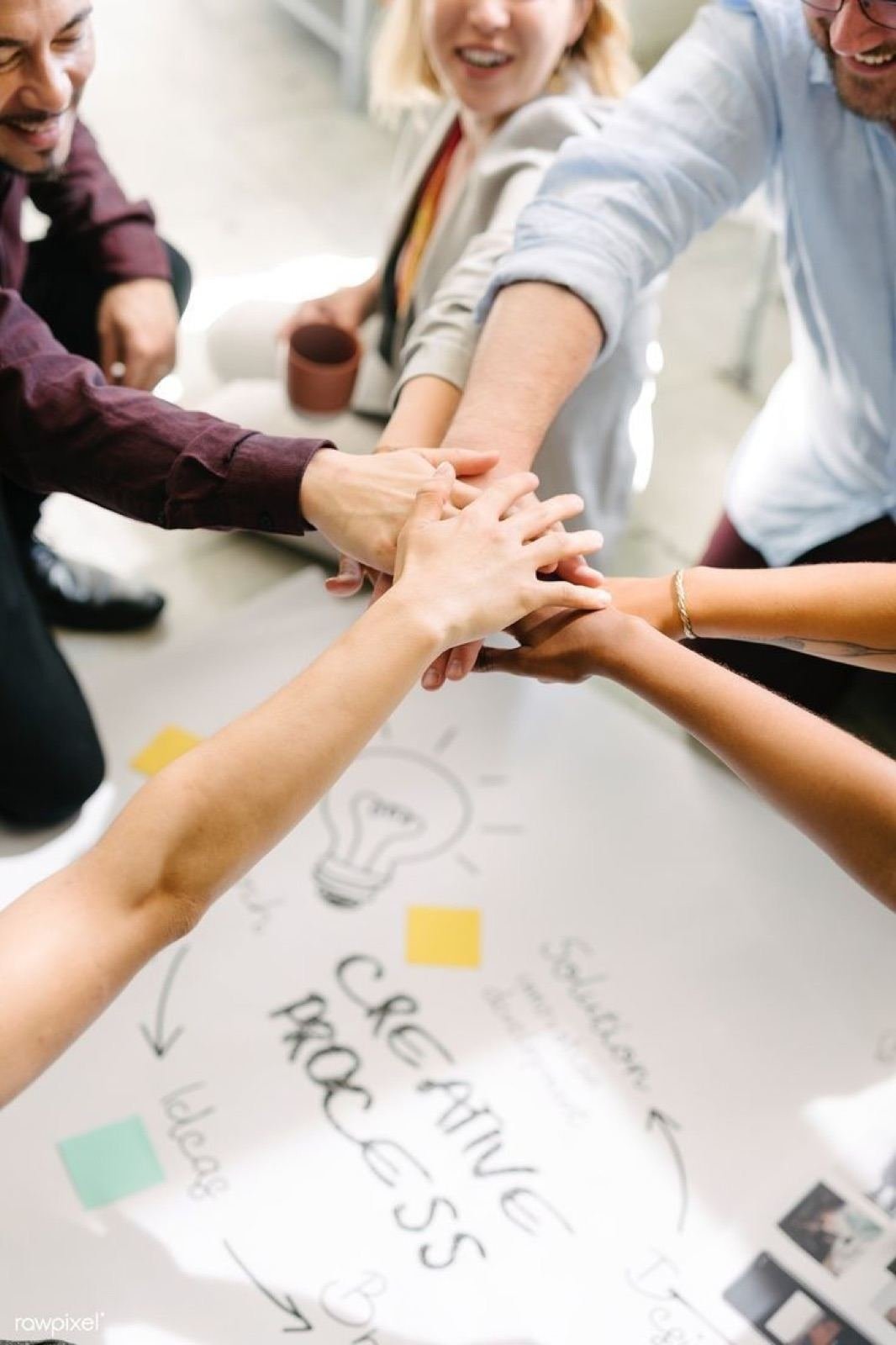 Hands stacked together in a show of teamwork