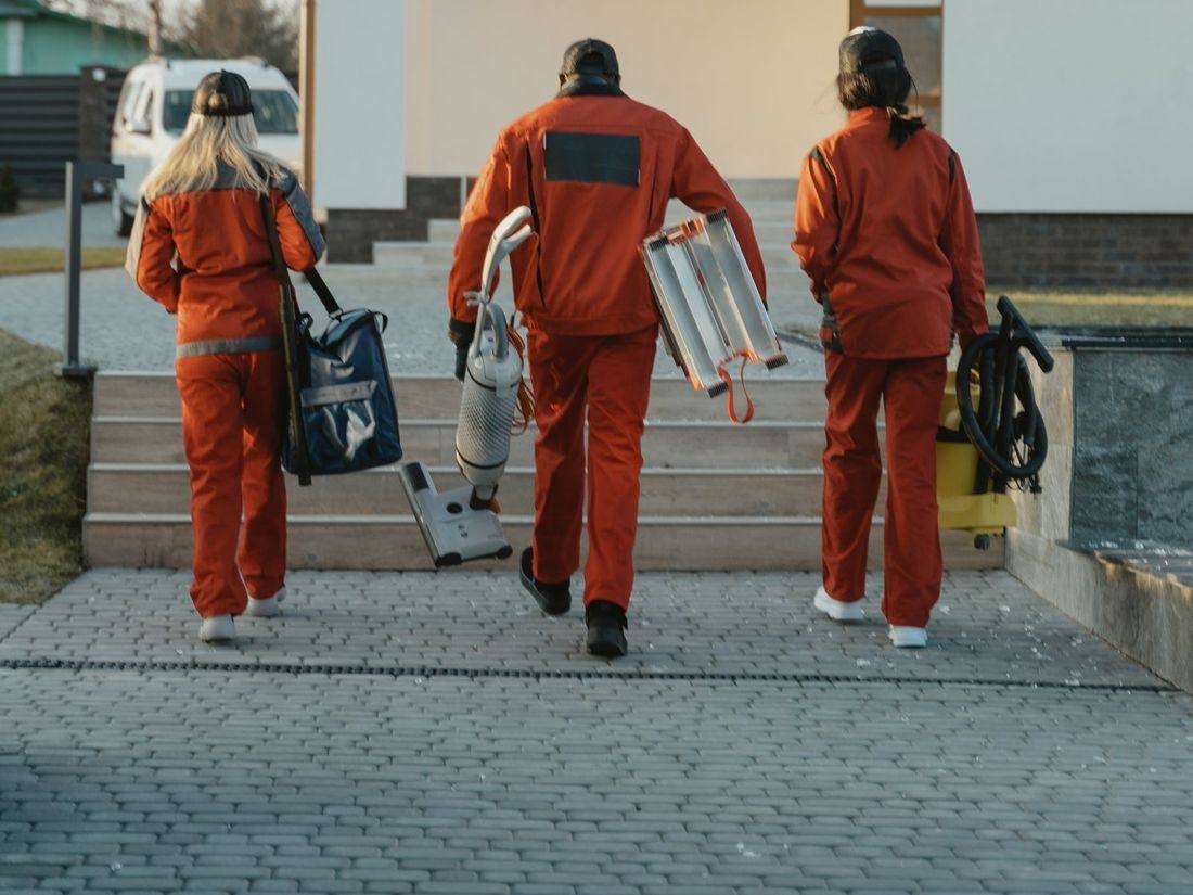 Cleaning team arriving at a client's home with equipment