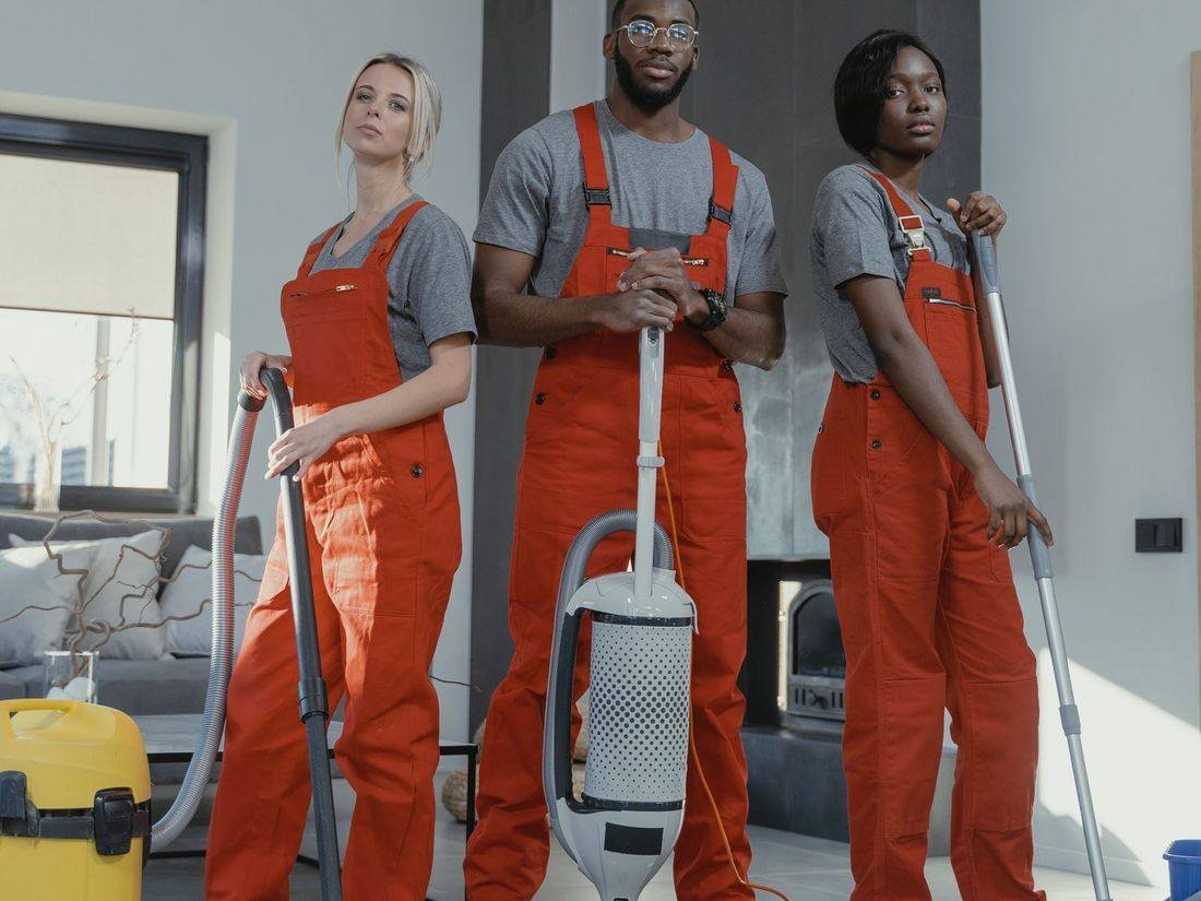 Professional cleaning team ready to start work in a living room