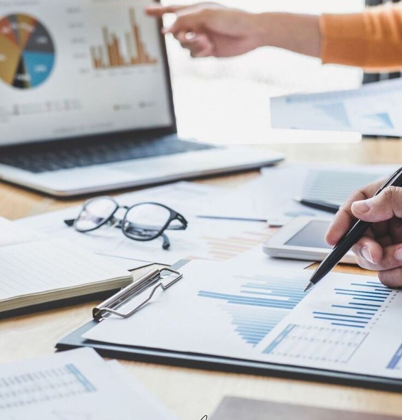 Business charts being reviewed at a desk
